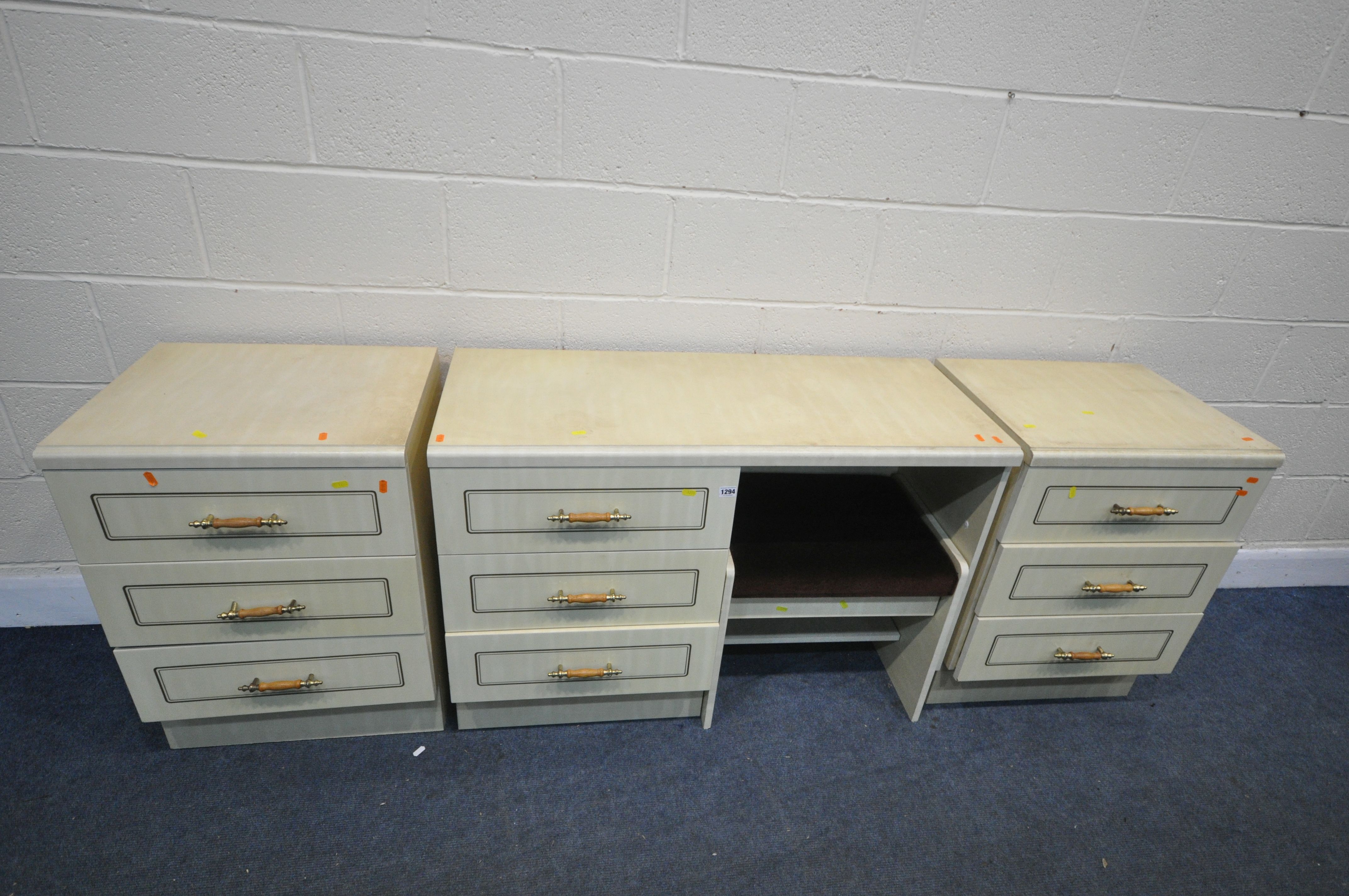 A CREAM FOUR PIECE BEDROOM SUITE, comprising a dressing table, with three drawers, length 107cm x