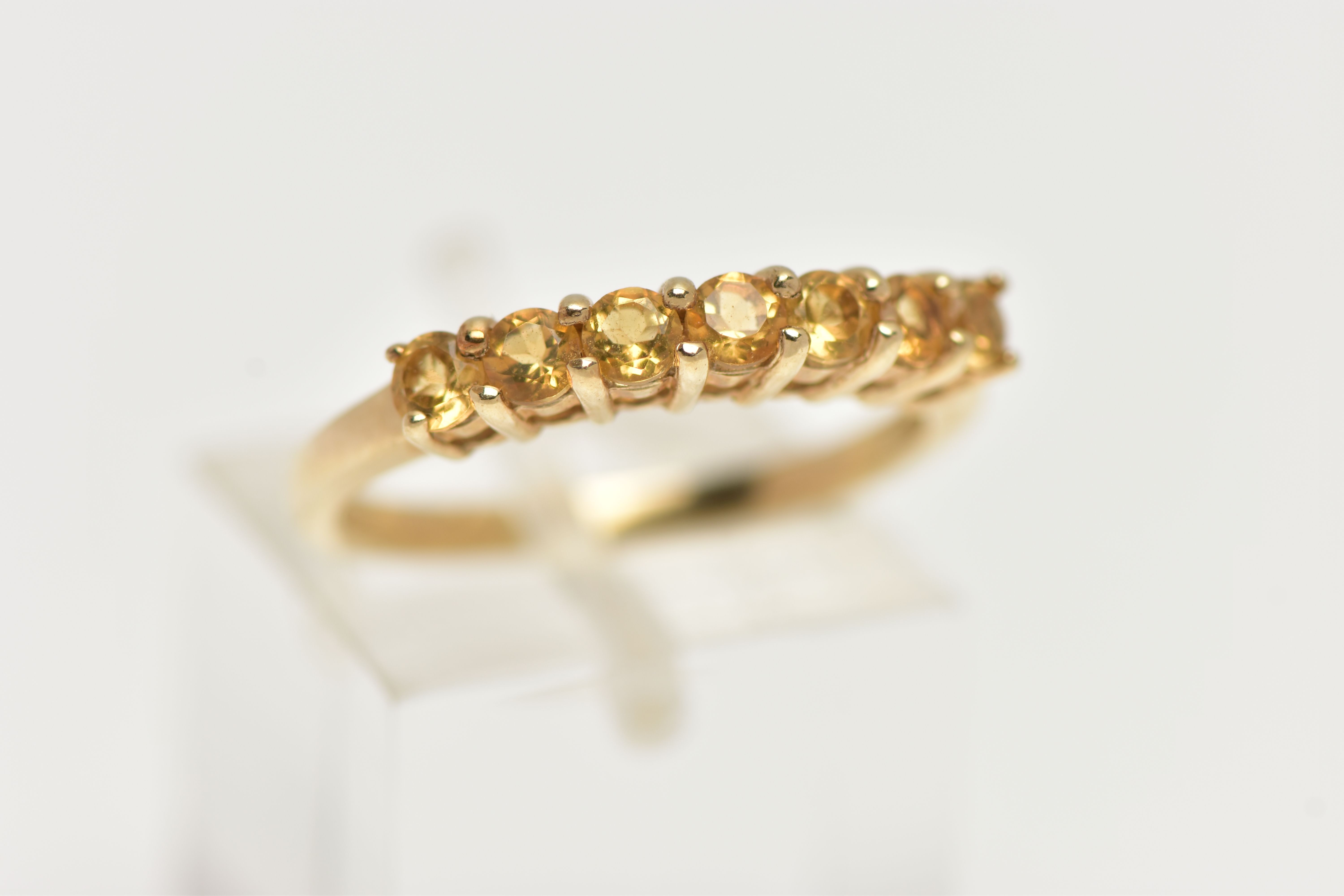 A 9CT GOLD CITRINE RING, designed with a row of seven circular cut citrines, to the polished band, - Image 4 of 4