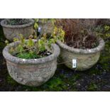 A PAIR OF WEATHERED COMPOSITE CIRCULAR PLANTERS, with a floral design, diameter 53cm x height