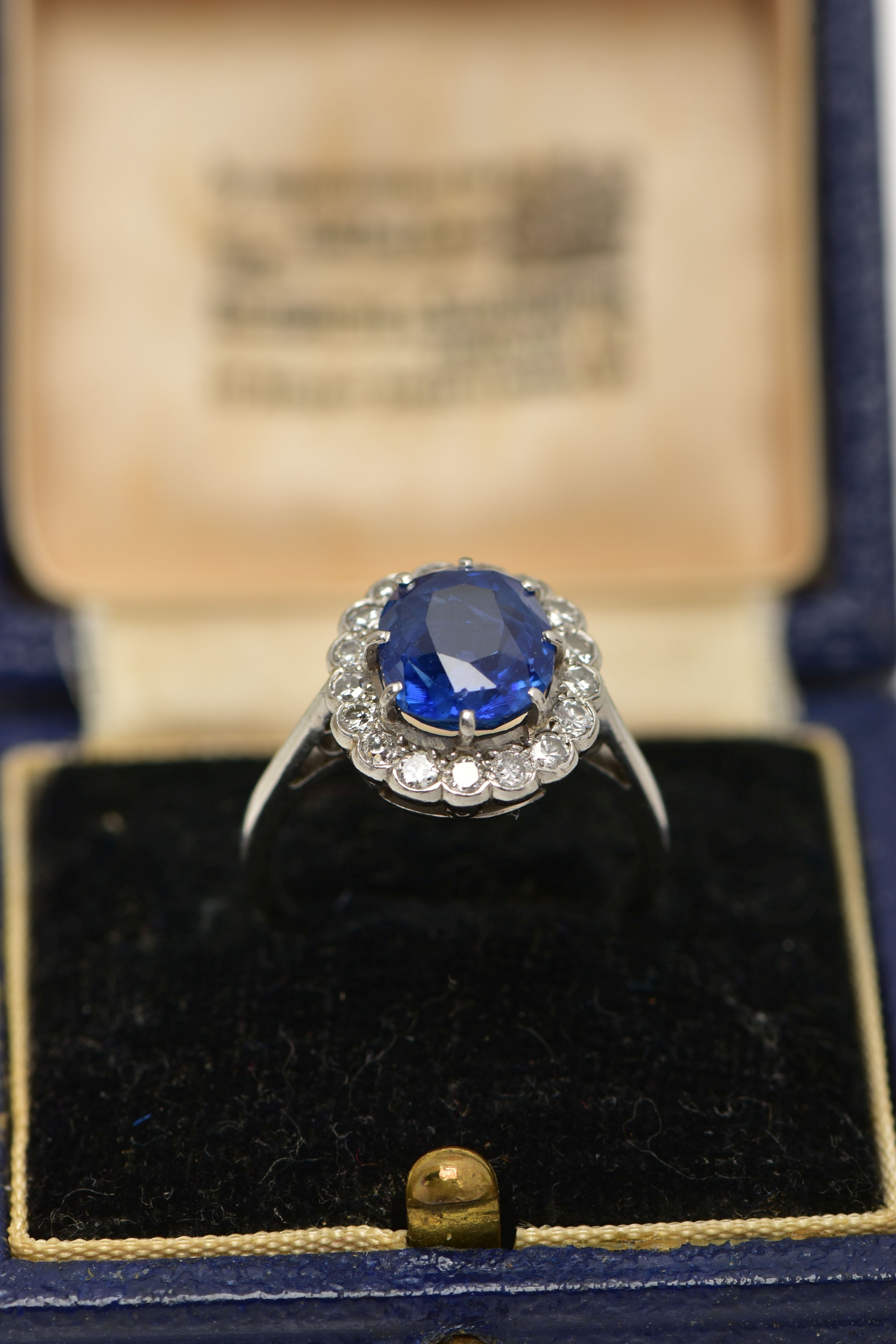 A SAPPHIRE AND DIAMOND CLUSTER RING, set with a mixed cut, cushion sapphire, measuring approximately - Image 11 of 13