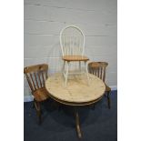 A PINE PEDESTAL DINING TABLE, diameter 107cm x height 75cm, two pitch pine kitchen chairs, and