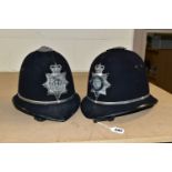 TWO POLICE OFFICERS HELMETS, with West Midlands Police badges and roses to top (one rose dented) (