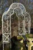 AN ARCHICTURAL WROUGHT IRON GARDEN ROSE ARBOUR, with a seat at each end, width 170cm x depth 93cm