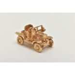 A 9CT GOLD CHARM, yellow gold charm of a car with moving wheels, hallmarked 9ct London,