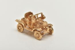 A 9CT GOLD CHARM, yellow gold charm of a car with moving wheels, hallmarked 9ct London,