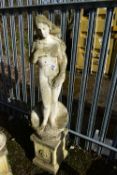 A WEATHERED COMPOSITE GARDEN FIGURE, of a nude lady standing on a shell, on a separate plinth,