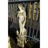 A WEATHERED COMPOSITE GARDEN FIGURE, of a nude lady standing on a shell, on a separate plinth,