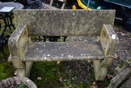 A WEATHERED COMPOSITE GARDEN BENCH, gothic taste, that dismantles into four pieces, length 129cm x