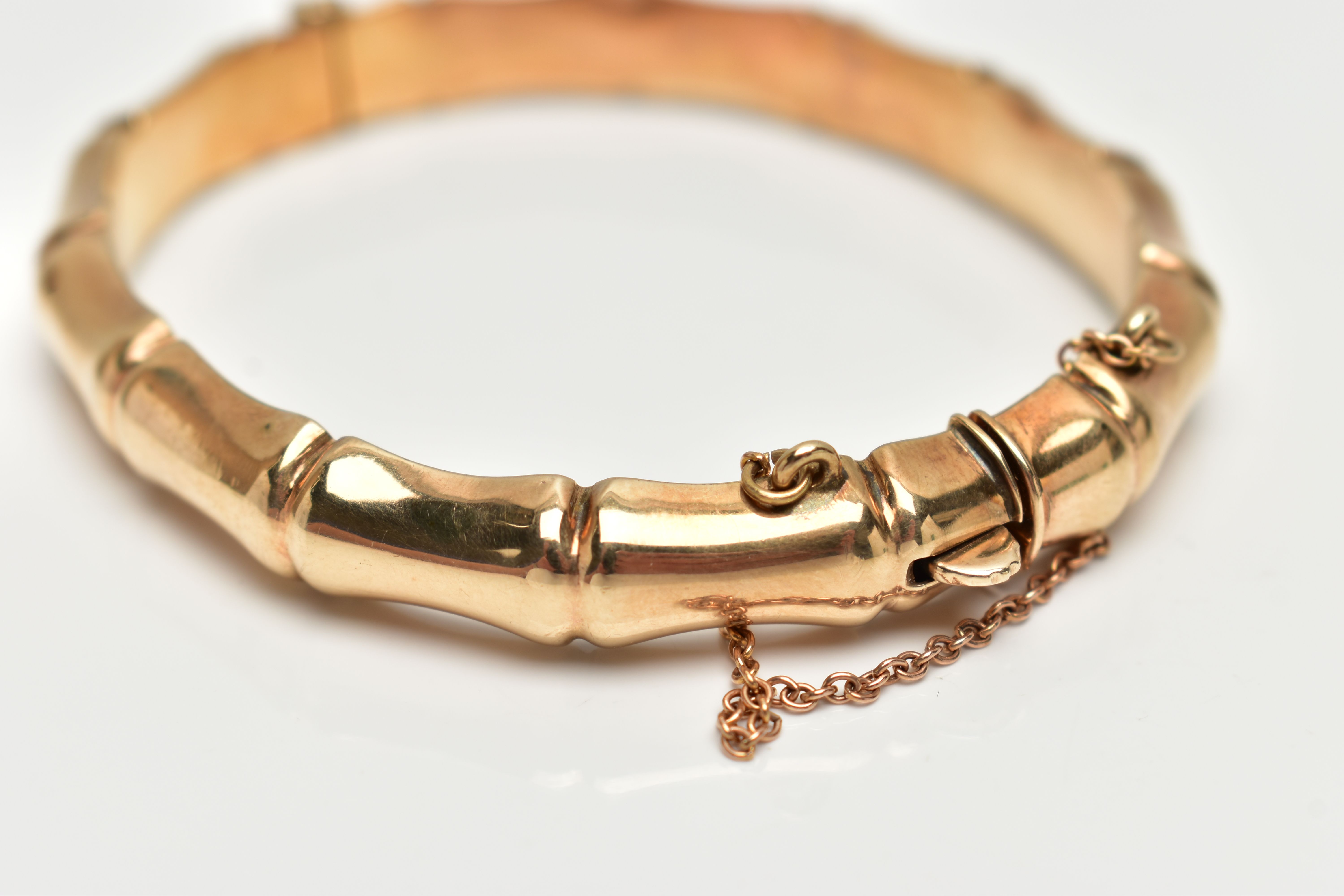 A 9CT GOLD 'SMITH & PEPPER' BANGLE, a yellow gold bamboo style hollow hinged bangle, fitted with - Image 3 of 3