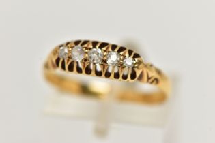 A FIVE STONE DIAMOND RING, five old cut diamonds prong set in yellow metal, stamp rubbed, ring