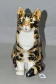 A WINSTANLEY TABBY AND WHITE CAT, no 5, in seated pose, having pale amber glass eyes, signed and