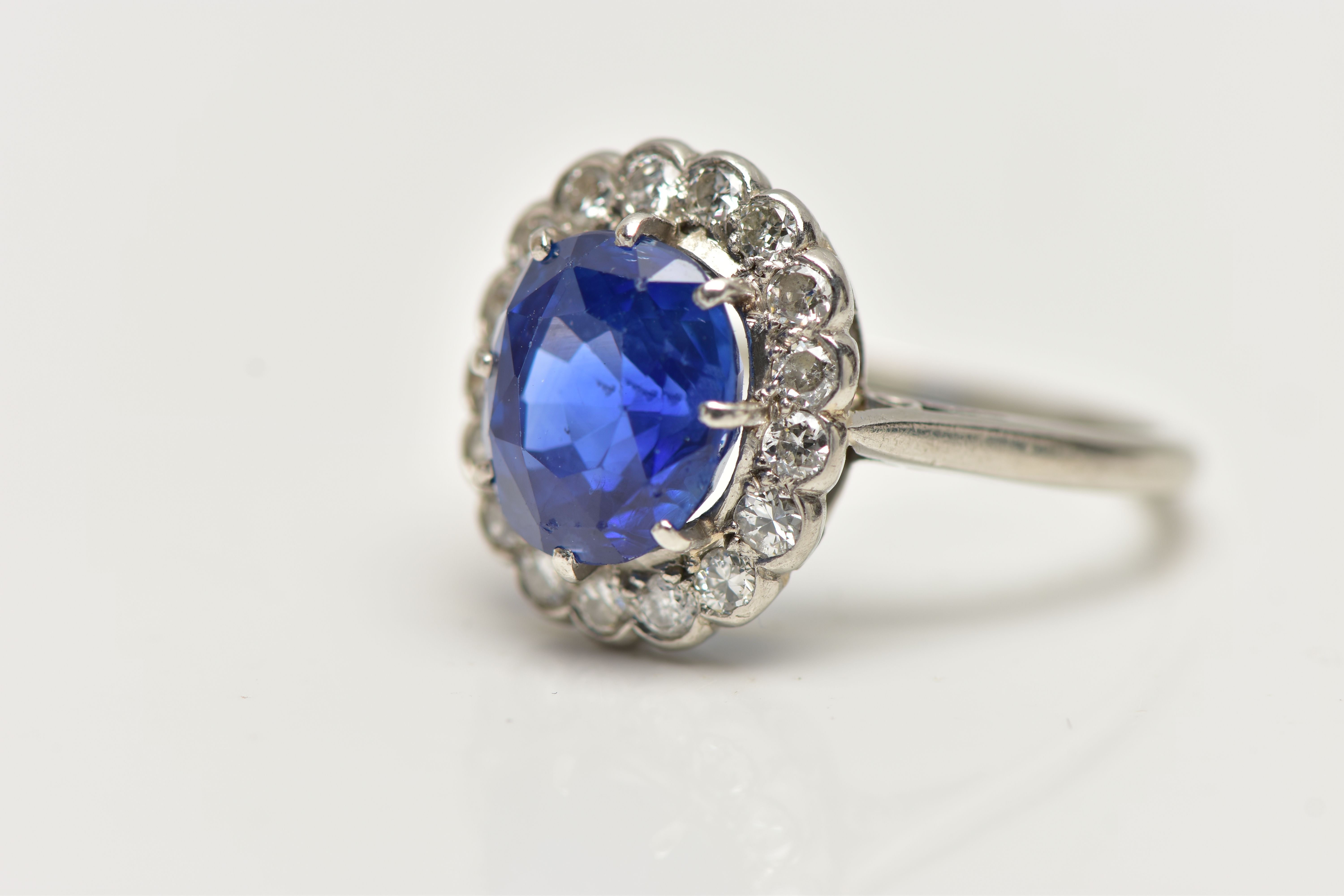 A SAPPHIRE AND DIAMOND CLUSTER RING, set with a mixed cut, cushion sapphire, measuring approximately - Image 7 of 13