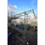 A LARGE METAL ARCHED GARDEN ARBOUR, with a scrolled design, length 282cm x depth 303cm height