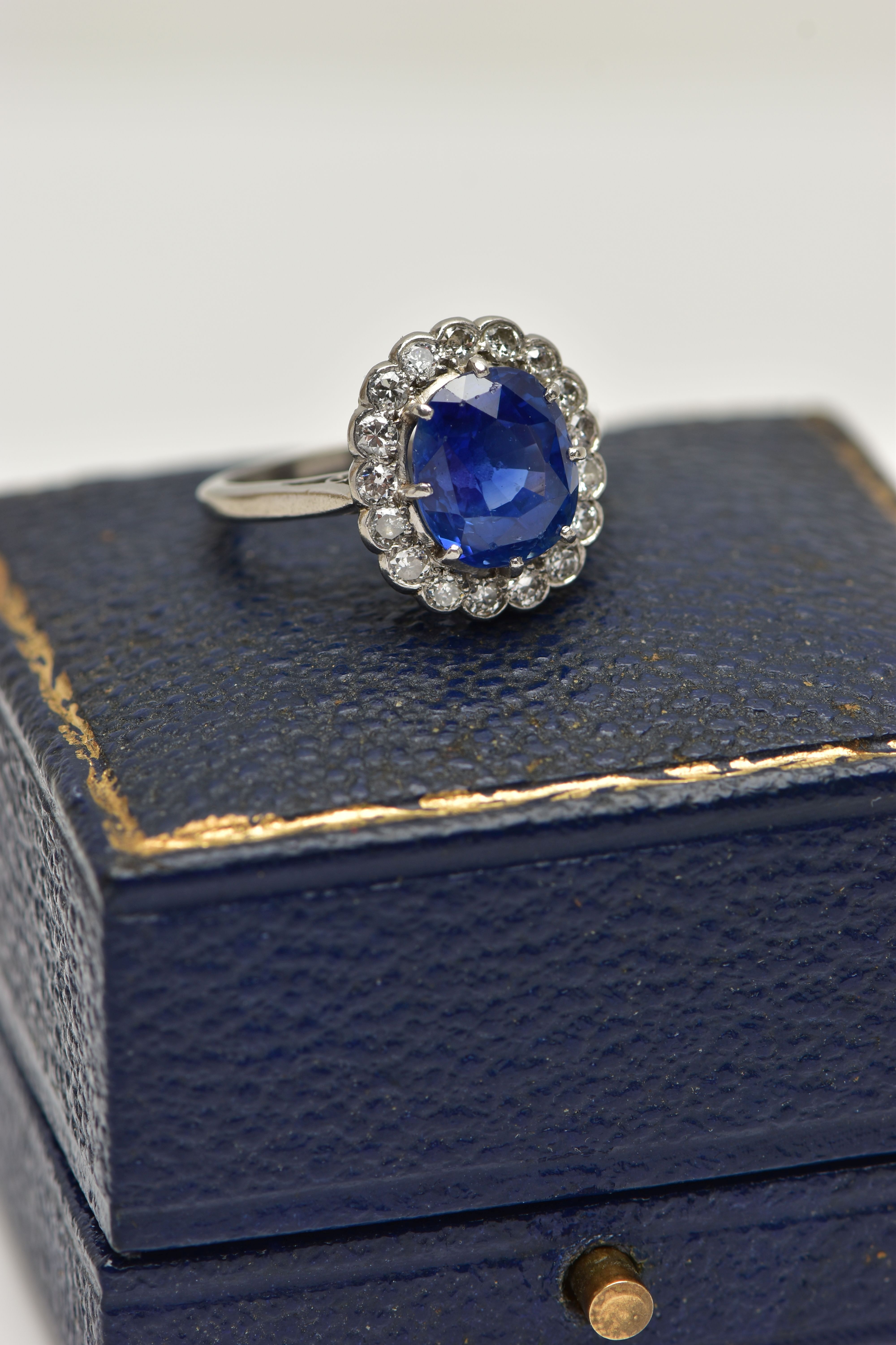 A SAPPHIRE AND DIAMOND CLUSTER RING, set with a mixed cut, cushion sapphire, measuring approximately - Image 10 of 13