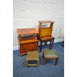 A YEWWOOD CABINET, with double cupboard doors, a yew wood magazine rack, a nest of three tables, and