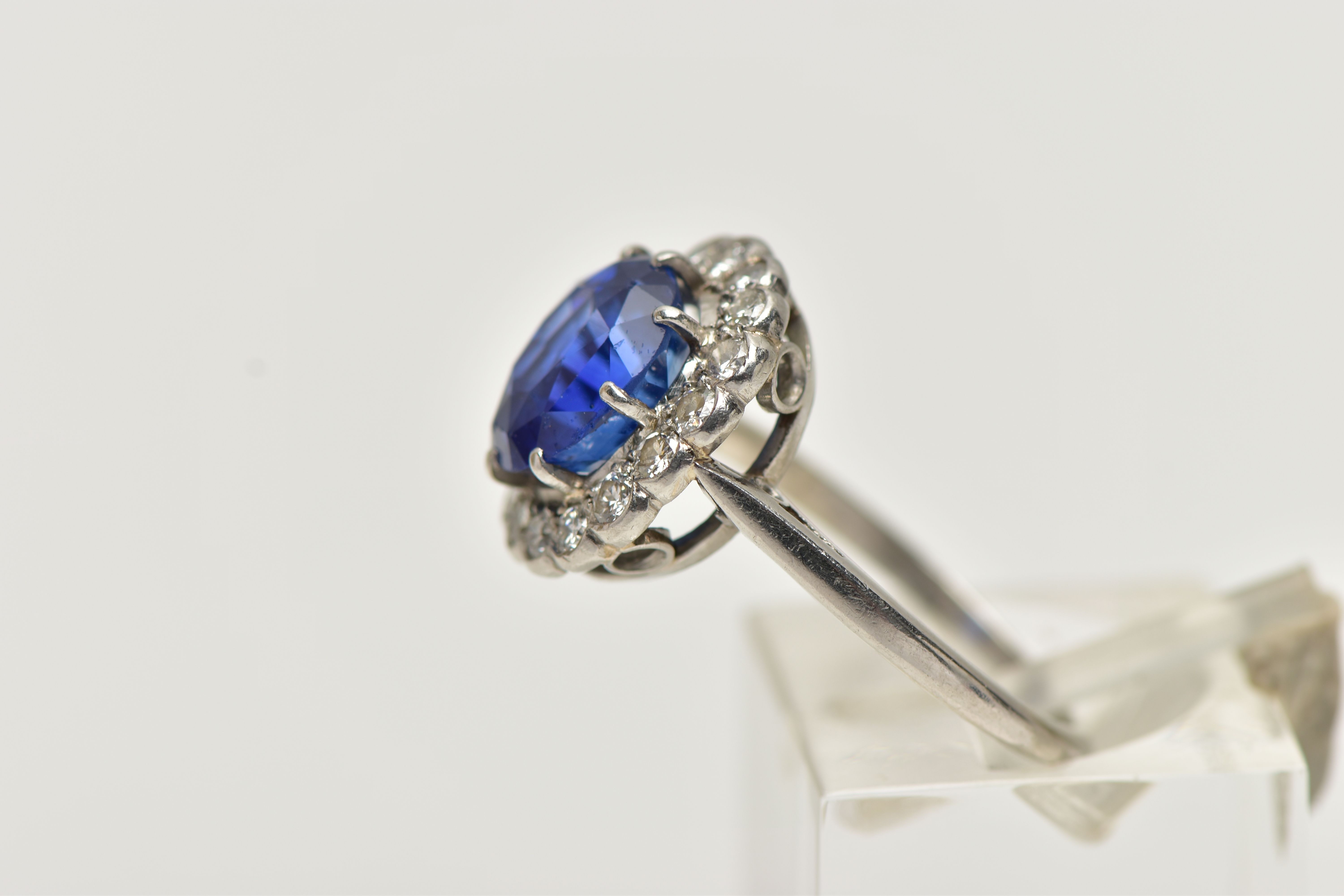 A SAPPHIRE AND DIAMOND CLUSTER RING, set with a mixed cut, cushion sapphire, measuring approximately - Image 2 of 13