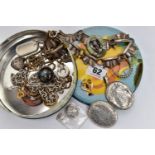 A SMALL TIN OF ASSORTED ITEMS, to include a rose metal lavalier pendant set with garnet and split