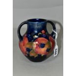 A MOORCROFT POTTERY POMEGRANATE TWIN HANDLED VASE, of amphora style, tube lined with pomegranates