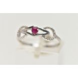 A 9CT WHITE GOLD RUBY RING, designed with a claw set, circular cut ruby, in an openwork mount