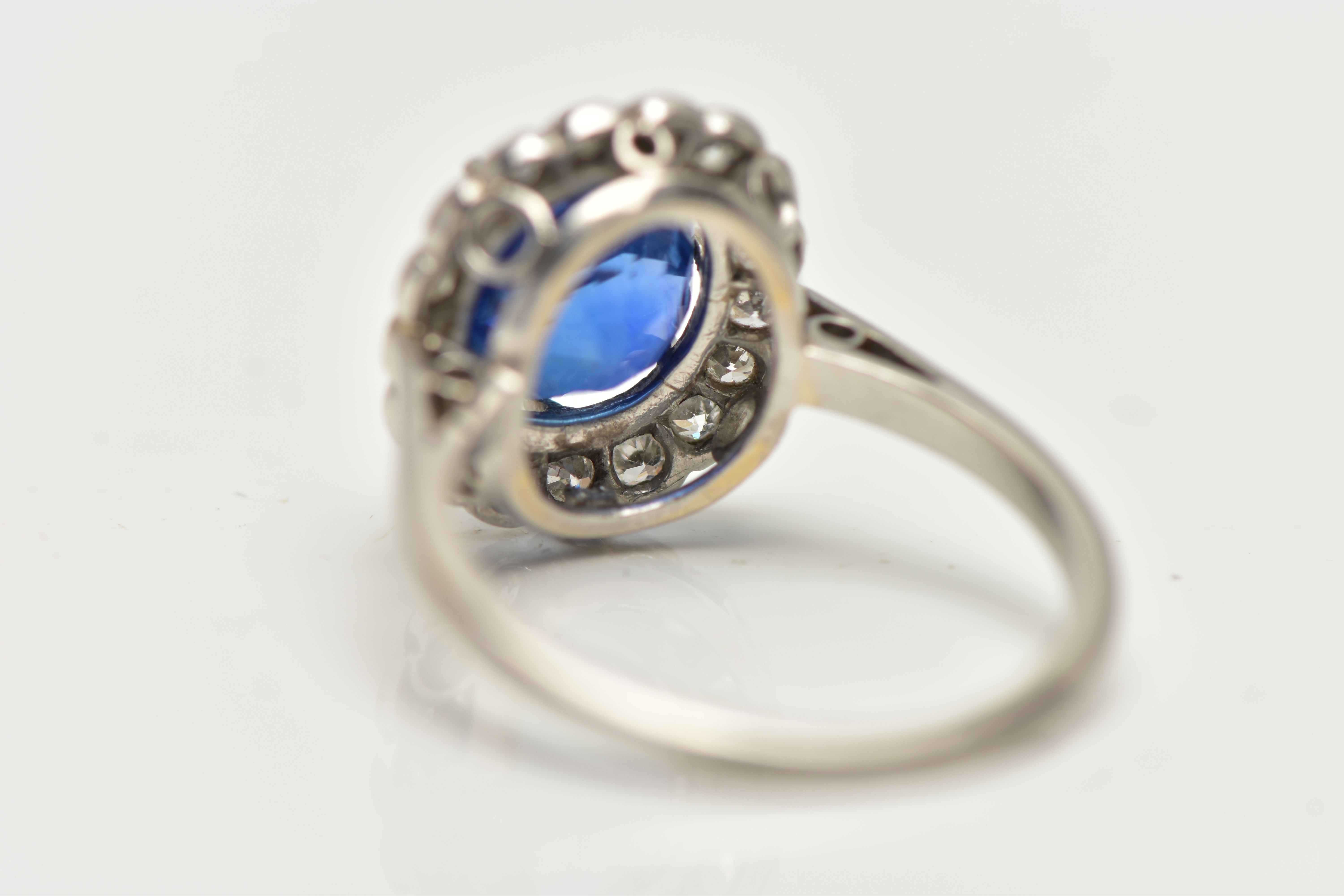 A SAPPHIRE AND DIAMOND CLUSTER RING, set with a mixed cut, cushion sapphire, measuring approximately - Image 9 of 13