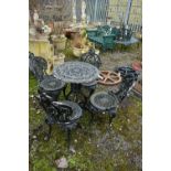 A PAINTED CAST IRON CIRCULAR GARDEN TABLE, diameter 59cm x height 70cm and four chairs (condition:-