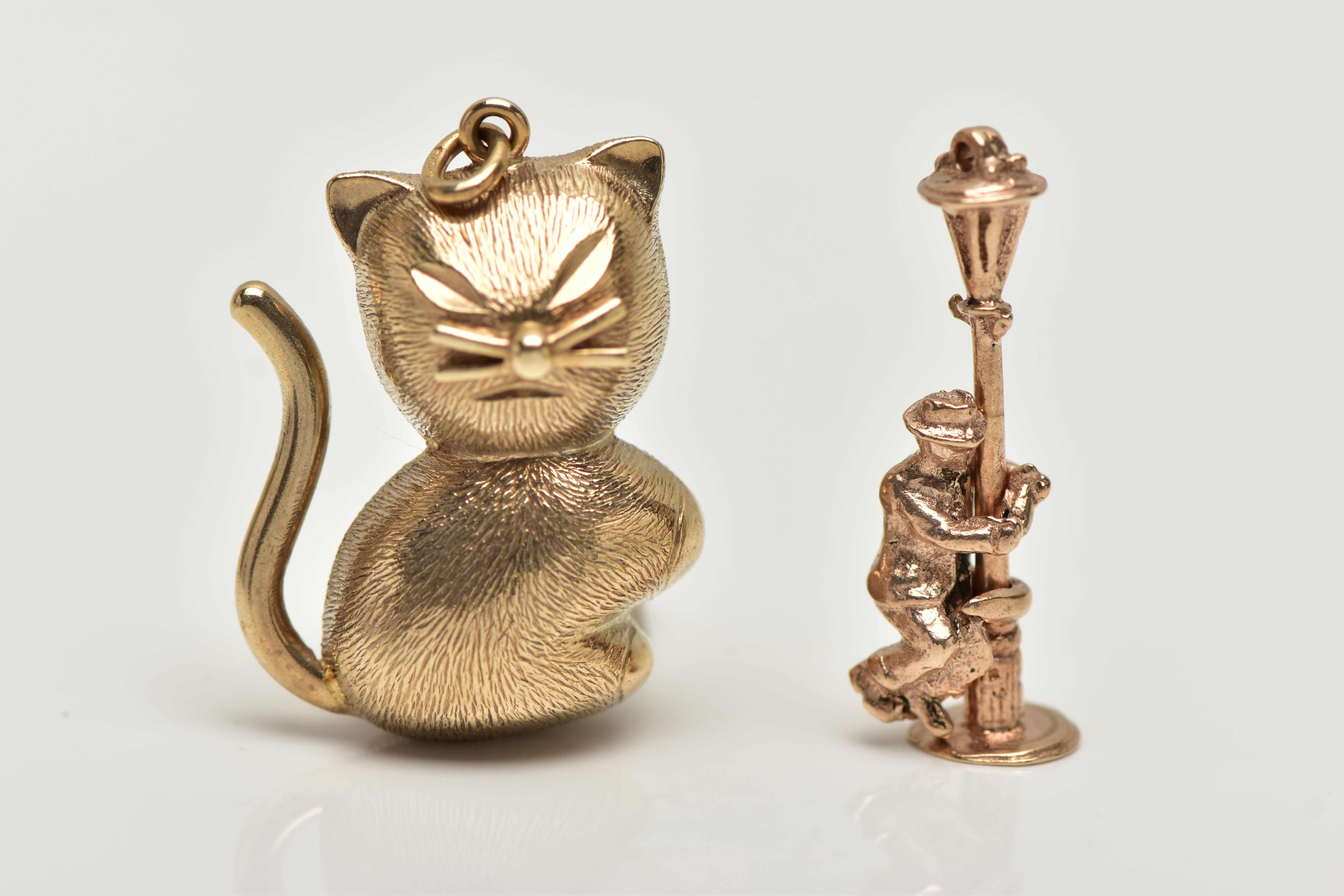 TWO 9CT GOLD CHARMS, the first a yellow gold cat charm, hallmarked 9ct Birmingham import,