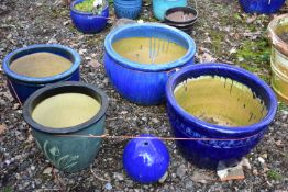 FOUR GLAZED PLANTERS, three blue glazed, and one green, largest and a glazed water feature (