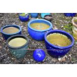 FOUR GLAZED PLANTERS, three blue glazed, and one green, largest and a glazed water feature (