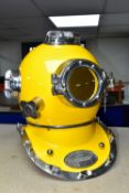 A REPRODUCTION US NAVY DIVING HELMET, for decorative purposes, bright yellow orange finish, plaque