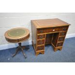 A REPRODUCTION YEWWOOD KNEE HOLE DESK, with a brown leather writing surface, width 76cm x depth 50cm