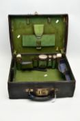 A GEORGE V BLACK LEATHER DRESSING CASE, green fabric lined interior with brown leather trim, the