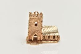 A 9CT GOLD CHARM, yellow gold charm of a church, hinged base, opens to reveal a wedding,