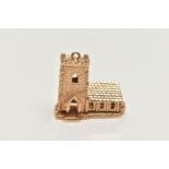 A 9CT GOLD CHARM, yellow gold charm of a church, hinged base, opens to reveal a wedding,