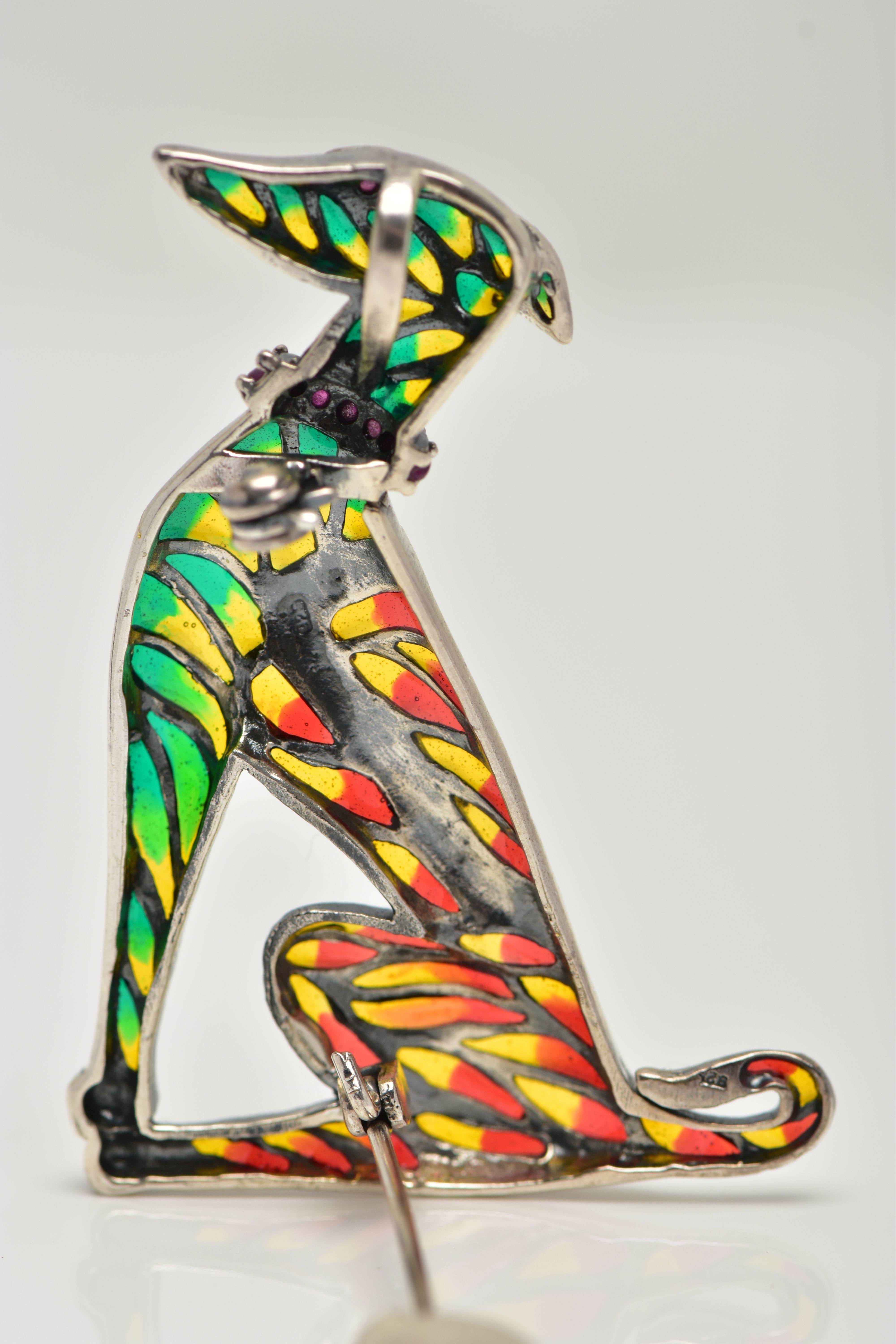 A WHITE METAL PLIQUE A JOUR BROOCH, in the form of a seated dog, decorated with red, green and - Image 2 of 2