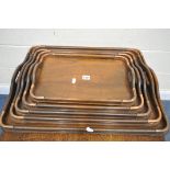 A MID CENTURY SET OF OAK GRADUATED TRAYS, with copper corners, largest tray measurements, 62cm x