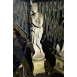 A WEATHERED COMPOSITE GARDEN FIGURE, of a scantily clad lady in flowing robes, on a separate plinth,
