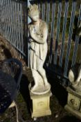 A WEATHERED COMPOSITE GARDEN FIGURE, of a scantily clad lady in flowing robes, on a separate plinth,