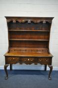 A REPRODUCTION GEORGIAN STYLE OAK AND CROSSBANDED DRESSER, the top plate rack top with a wavy apron,
