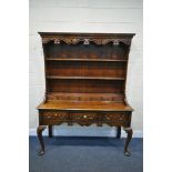 A REPRODUCTION GEORGIAN STYLE OAK AND CROSSBANDED DRESSER, the top plate rack top with a wavy apron,