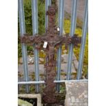 A WEATHERED CAST IRON CRUCIFIX, the cross decorated fruiting flower and leaf vines, width 75cm x
