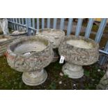 A SET OF THREE WEATHERED COMPOSITE PLANTERS, on separate bases, diameter 45cm x height 45cm (