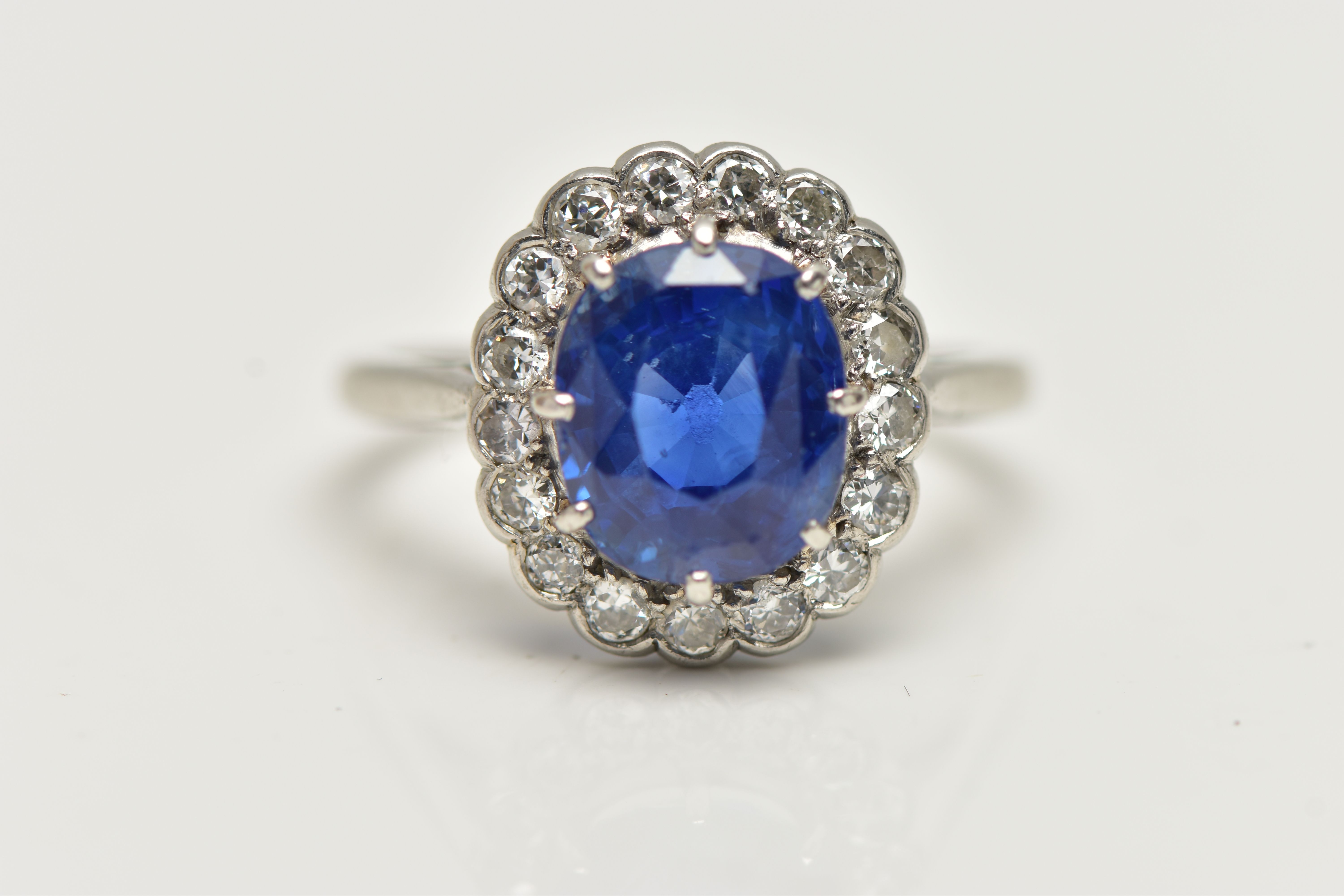 A SAPPHIRE AND DIAMOND CLUSTER RING, set with a mixed cut, cushion sapphire, measuring approximately - Image 5 of 13