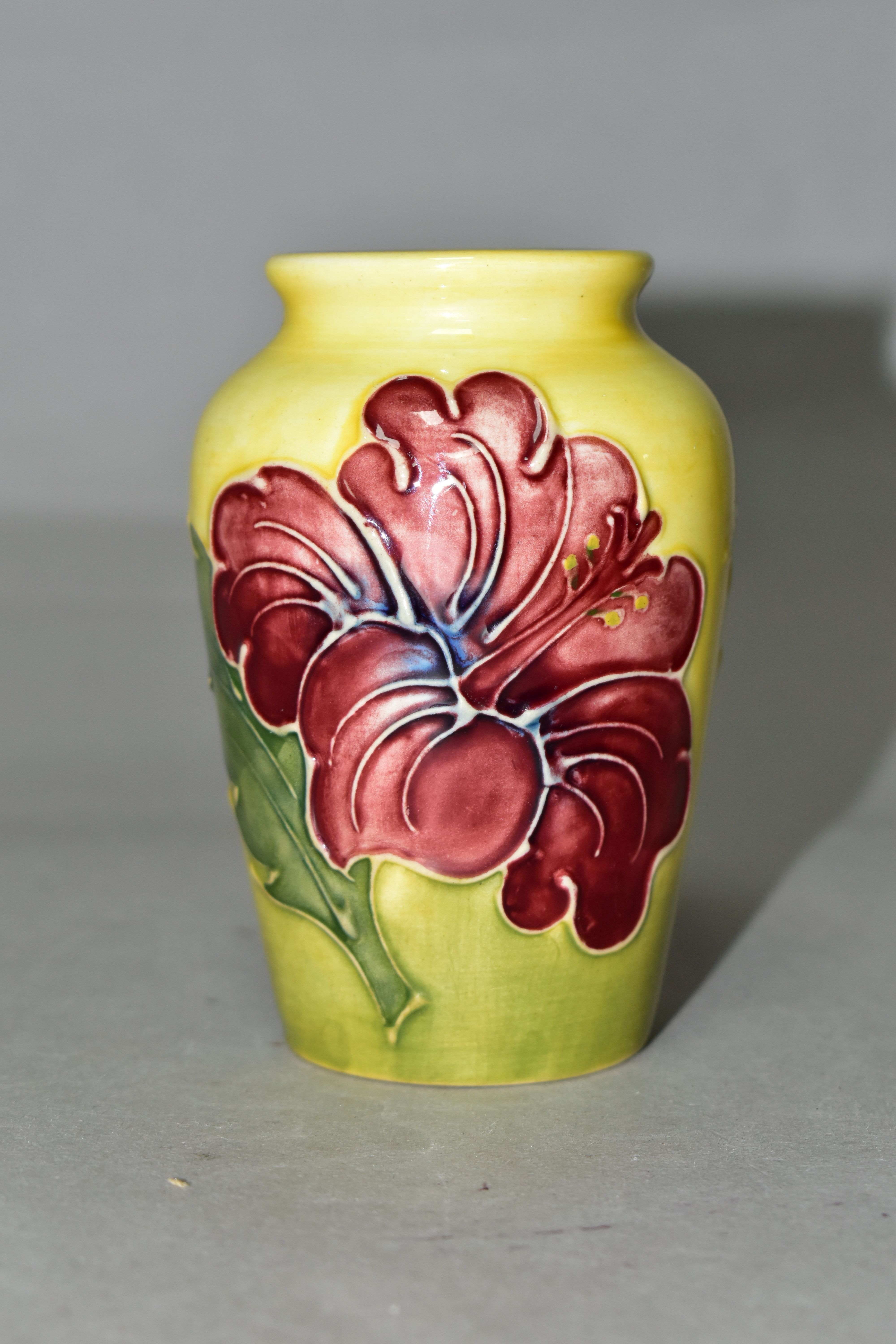 A SMALL MOORCROFT POTTERY HIBISCUS VASE, tube lined with red/purple hibiscus on a graduated yellow - Image 2 of 4