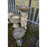 A WEATHERED COMPOSITE FIGURAL BIRD BATH, circular top, on a loose base depicting a putto, diameter