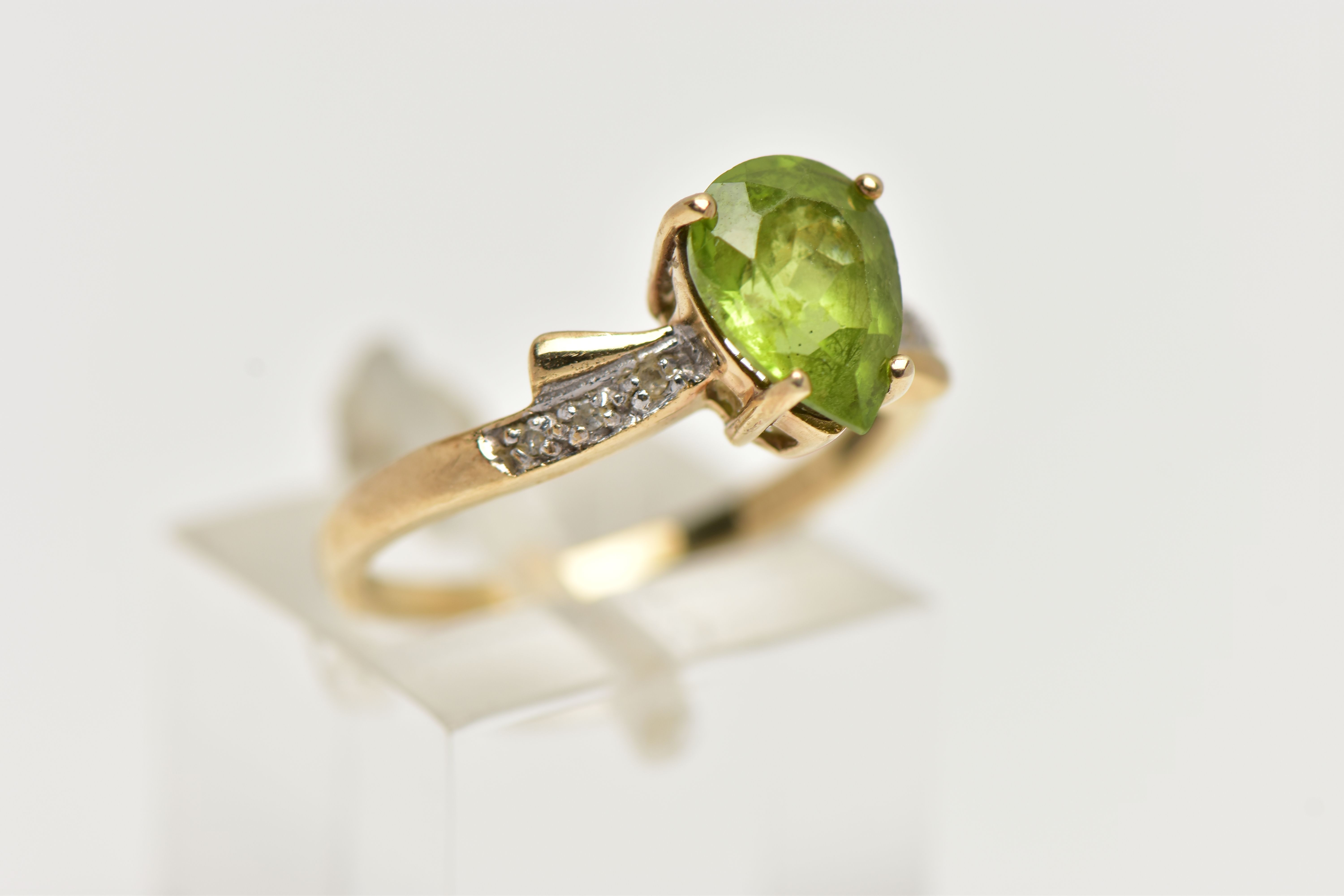 A 9CT GOLD, PERIDOT AND DIAMOND RING, designed with a four claw set, pear cut peridot, flanked - Image 4 of 4