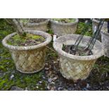 A PAIR OF WEATHERED COMPOSITE CIRCULAR TAPERED PLANTERS, with a lattice design, diameter 53cm x