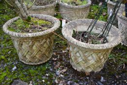 A PAIR OF WEATHERED COMPOSITE CIRCULAR TAPERED PLANTERS, with a lattice design, diameter 53cm x