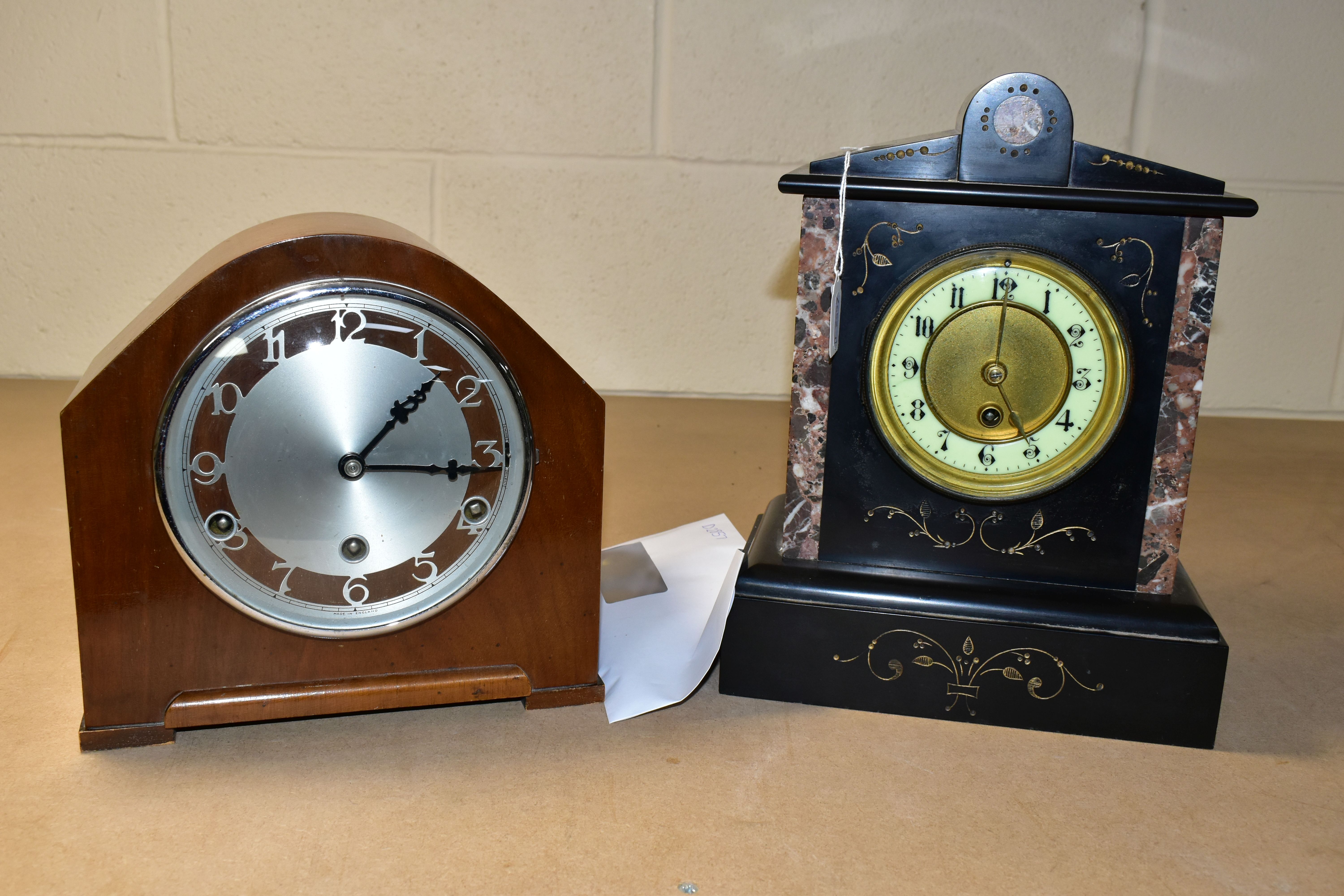 TWO MANTEL CLOCKS, comprising a black slate mantel clock with red marble inserts, engraved foliate