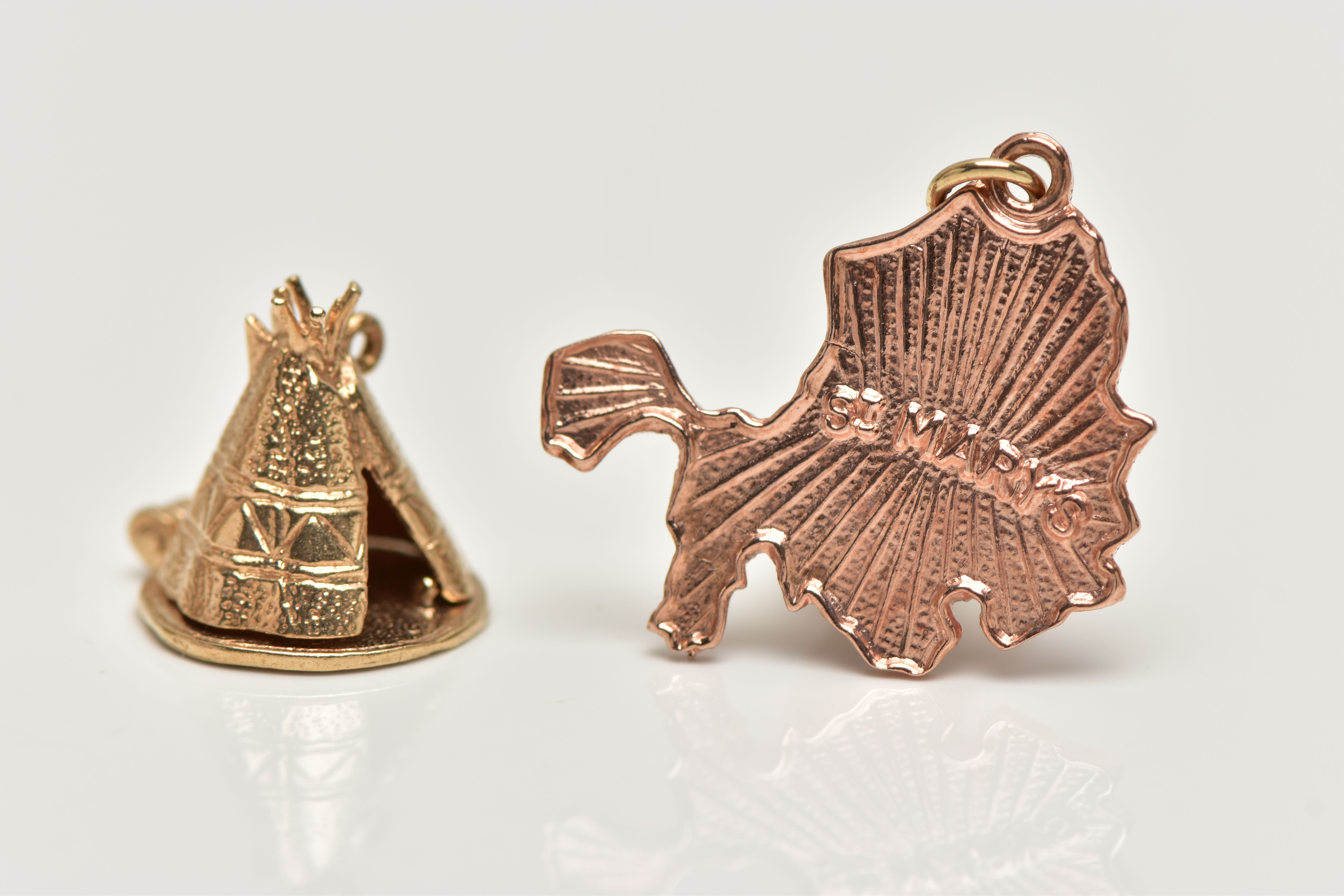 TWO 9CT GOLD CHARMS, the first a yellow gold charm of a tipi with a hinged base revealing a native