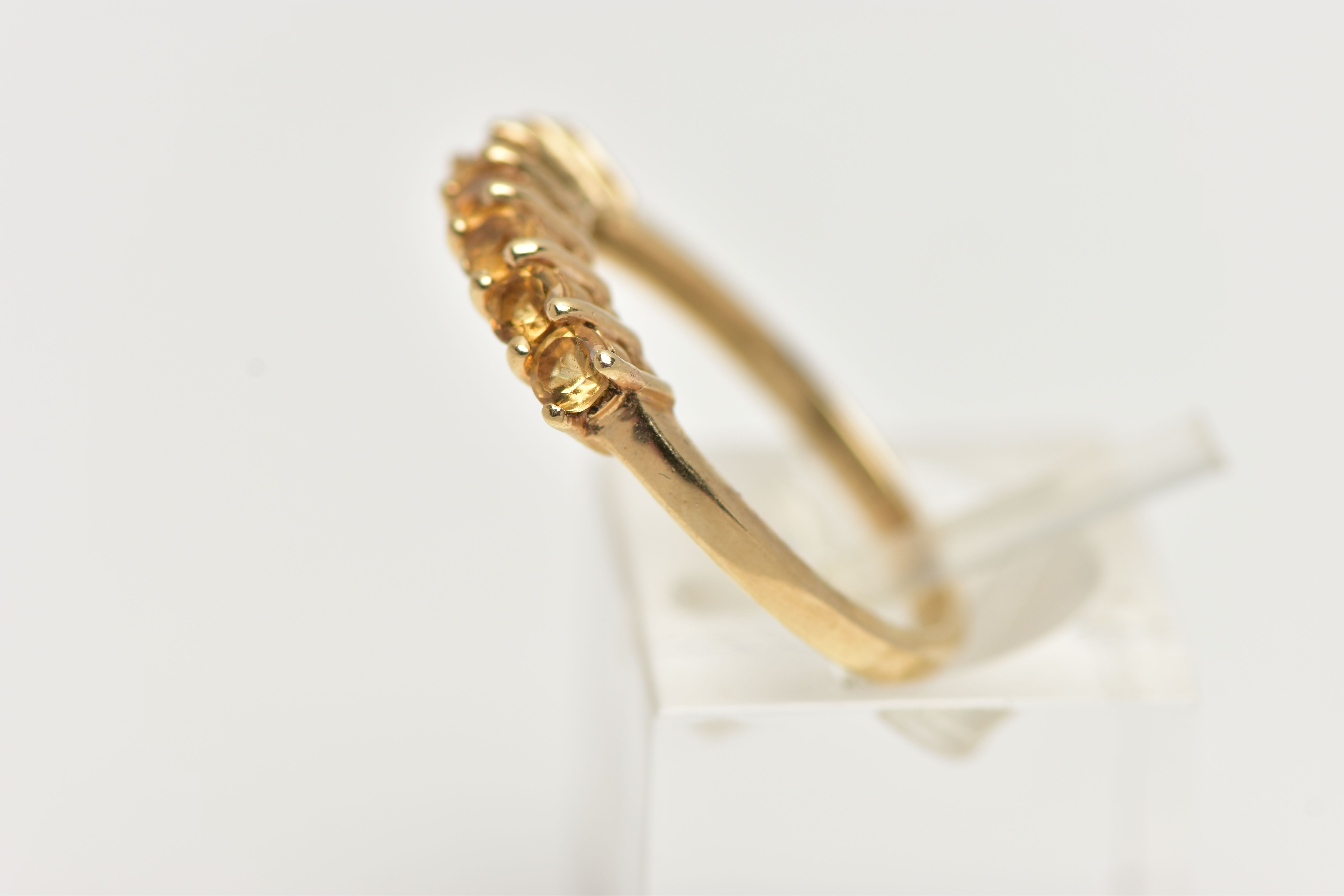 A 9CT GOLD CITRINE RING, designed with a row of seven circular cut citrines, to the polished band, - Image 2 of 4
